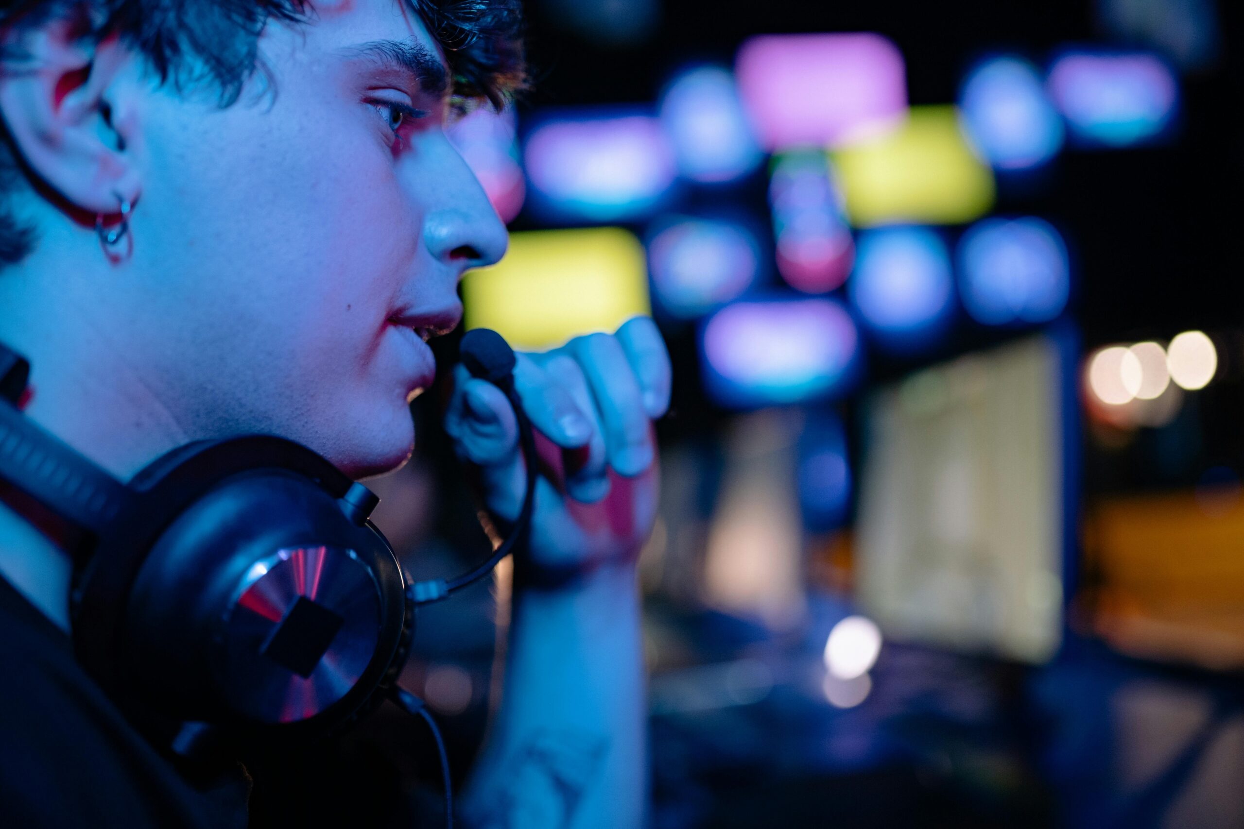 A competitive esports athlete holding a low-sugar energy bar between matches