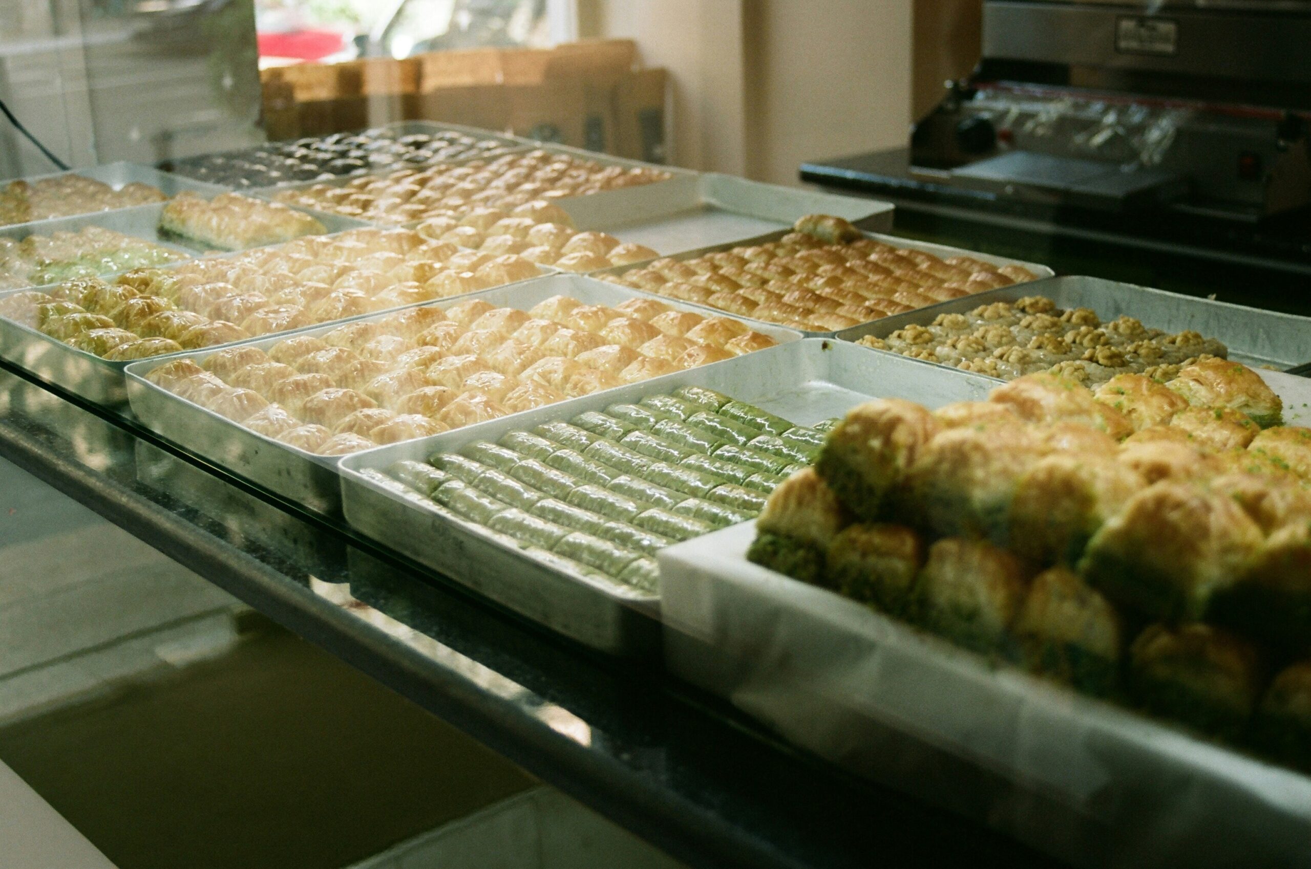 A neatly arranged tray of homemade kale chips, banana bread bites, and roasted chickpeas.