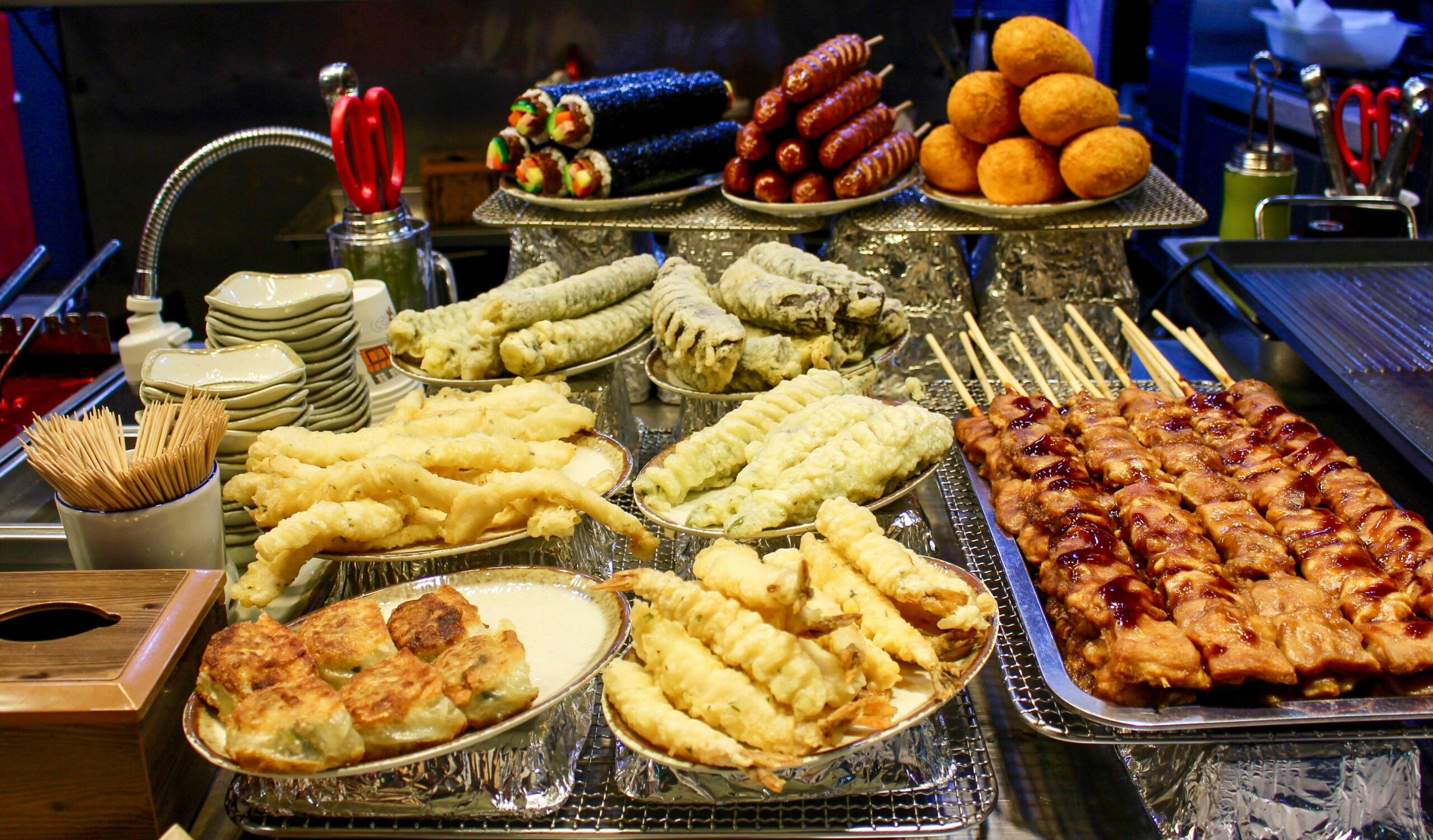 An assortment of gluten-free snacks including rice crackers, hummus, and fruit
