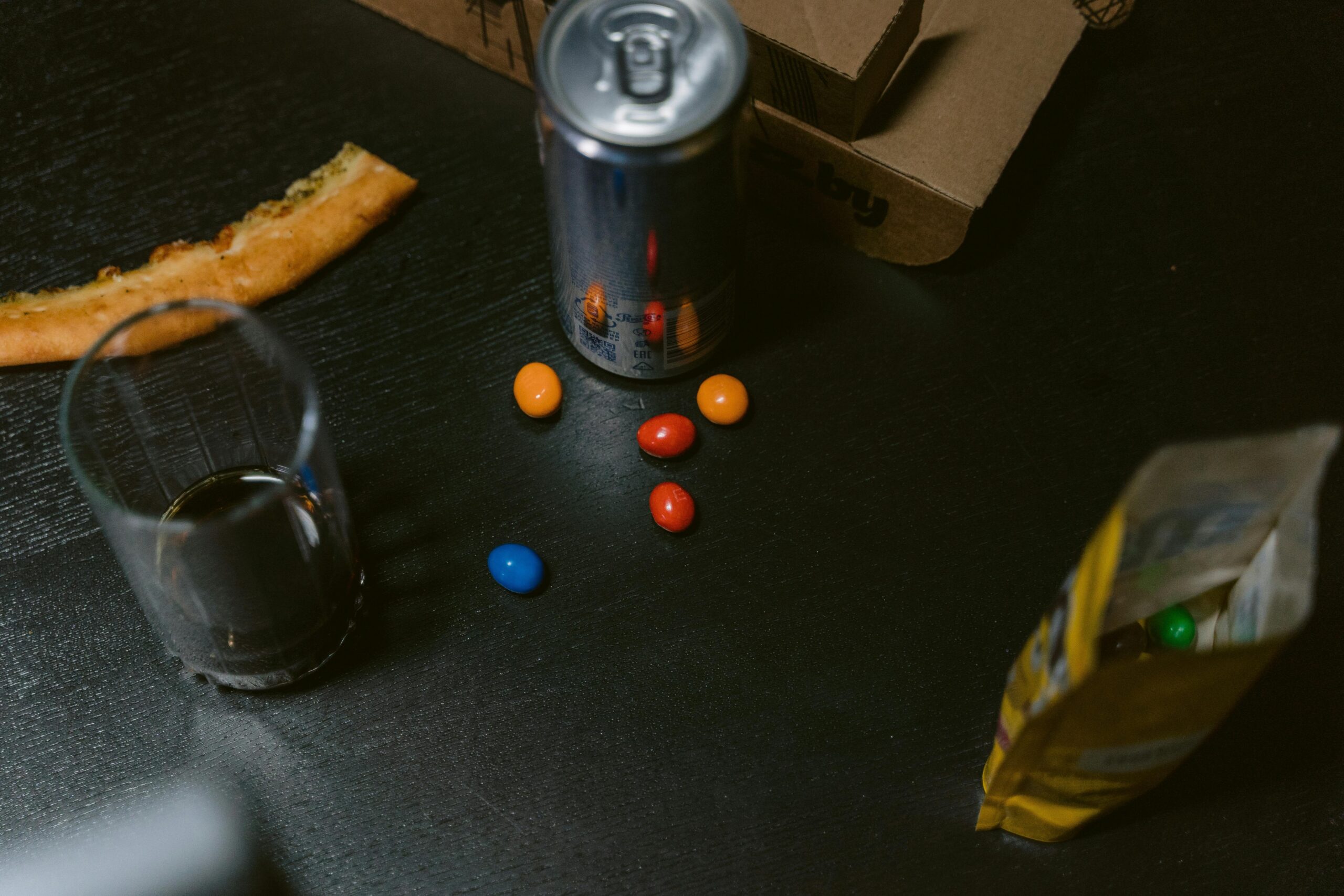 Gamer surrounded by empty snack bags and soda cans