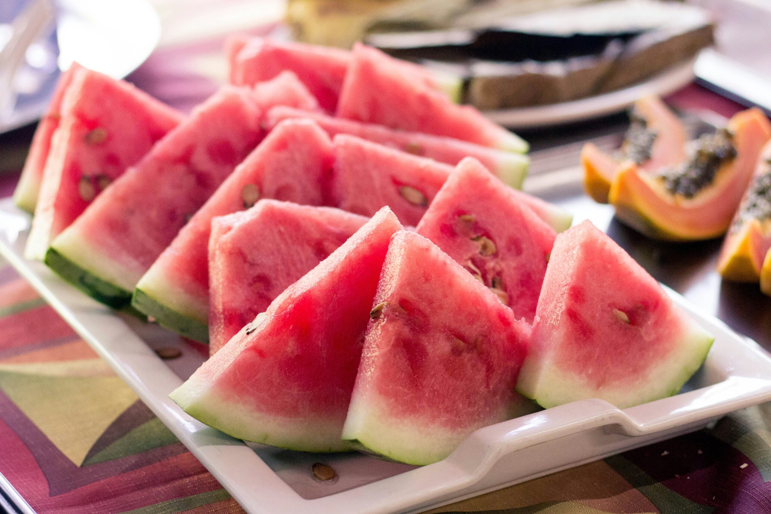 Plate of hydrating snacks like cucumber slices and watermelon chunks